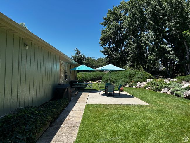 View of grassy yard featuring a patio | Image 4