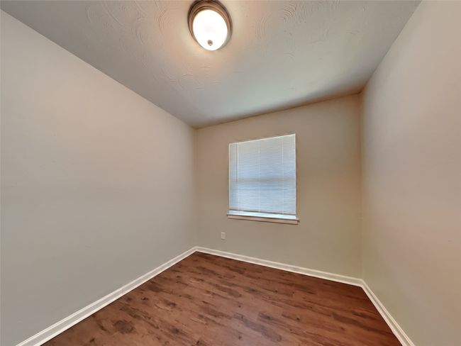 Unfurnished room with dark wood-style flooring and baseboards | Image 9
