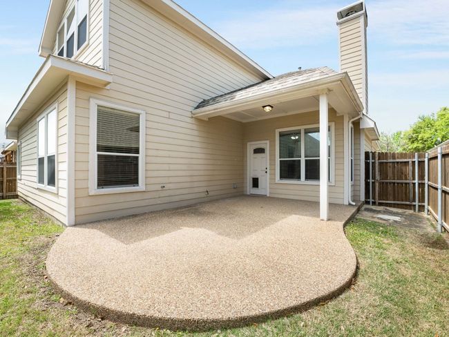 Back of house with a patio, a fenced backyard, and a chimney | Image 36