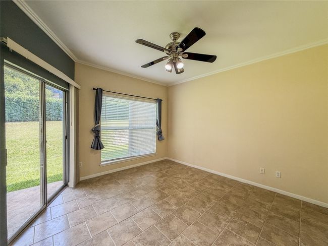 Unfurnished room featuring healthy amount of natural light, ornamental molding, and ceiling fan | Image 21