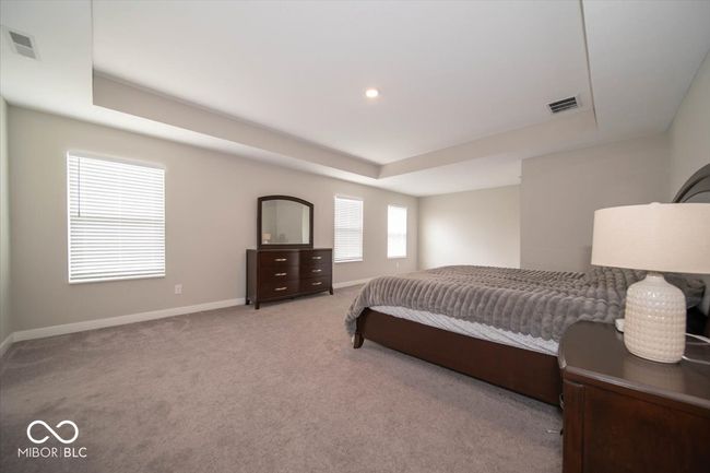 bedroom featuring a raised ceiling and carpet floors | Image 17