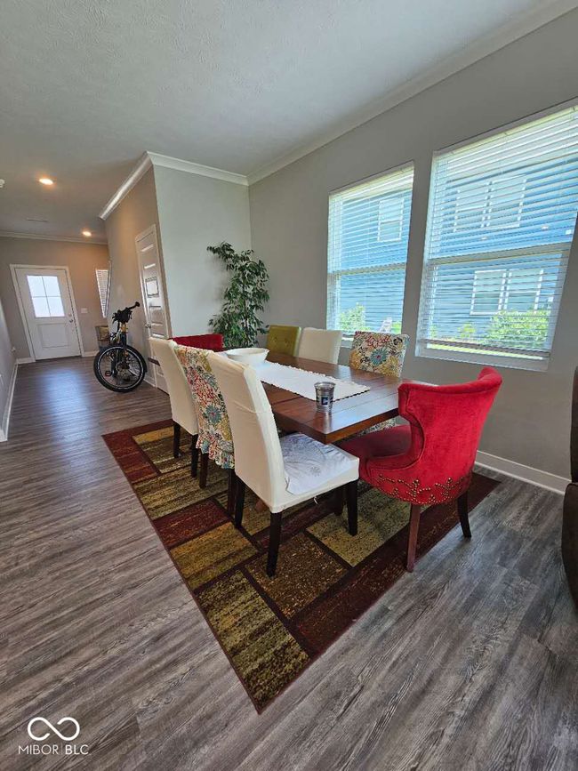 living area with wood finished floors, baseboards, ornamental molding, and recessed lighting | Image 12
