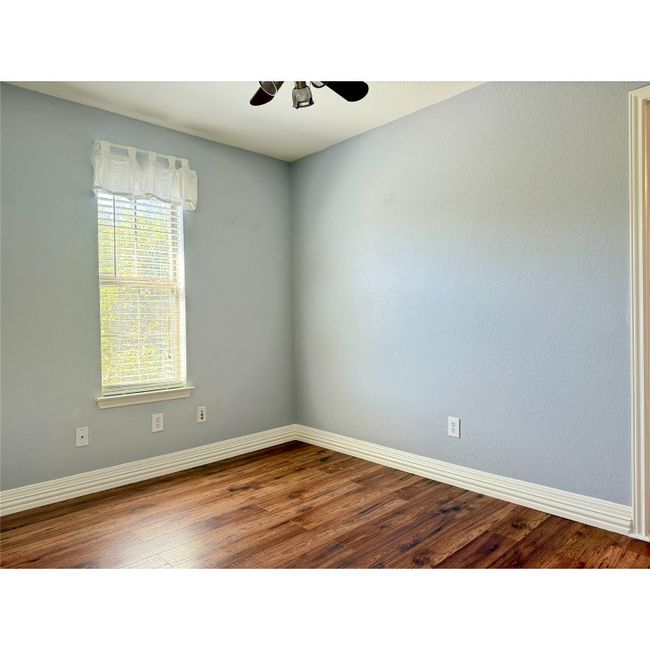 This room is located between the primary bedroom and bedroom number two. Works well as a home office, lounging area or nursery. Could also be split to create more closet space for the primary bedroom and create closet space for bedroom number two | Image 30