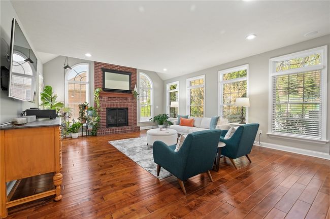 First floor family room off kitchen with hardwood floors, and brick gas fireplace. | Image 10