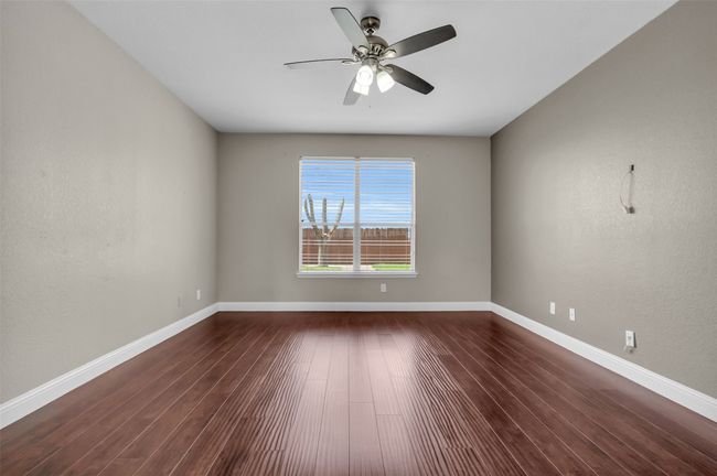 Primary bedroom with ceiling fan. | Image 14