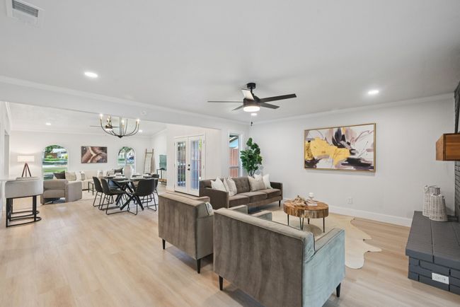 Living room with light wood-style flooring, french doors, recessed lighting, crown molding, and ceiling fan | Image 14