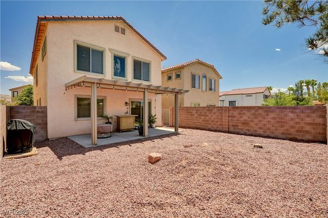 Rear view of house featuring stucco siding, a patio, and a fenced backyard | Image 29