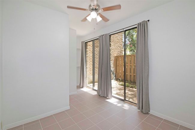 Downstairs room with Sliding doors to another Private Courtyard. | Image 25