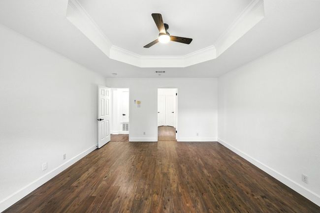 The smart floor plan includes a private primary suite tucked away at the back of the home. | Image 16
