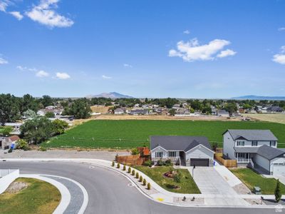 View of front facade with a garage and a lawn | Image 1