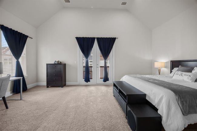Bedroom featuring vaulted ceiling, access to outside, and light carpet | Image 18