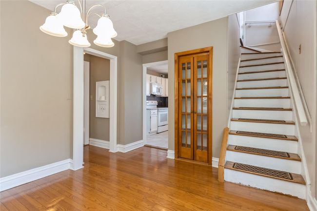 Stairs in the dining room lead to the seond floor. | Image 10