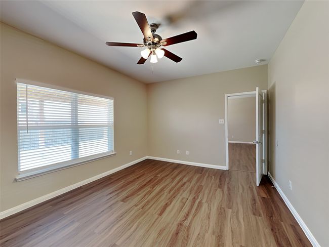 Spare room featuring wood finished floors, a ceiling fan, and a smoke detector | Image 7