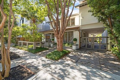 Decorative copper colored gutters adorn the front of the house, adding a unique and modern accent. The porte-chochere provides covered parking behind the electric gate. | Image 2