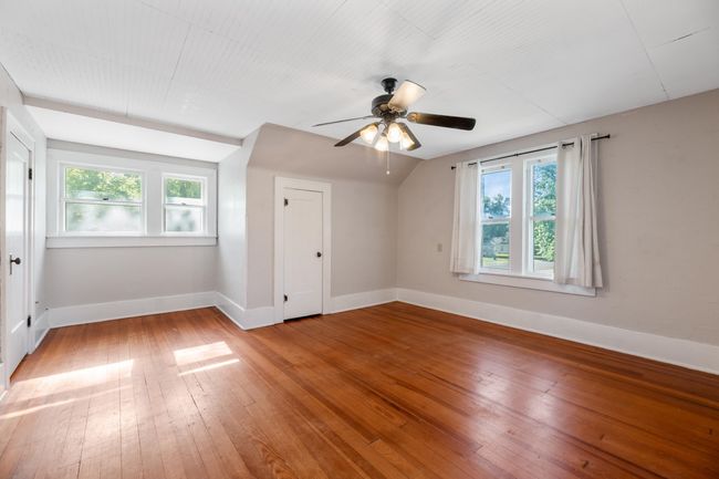 Bonus room with baseboards, plenty of natural light, light wood finished floors, a ceiling fan, and lofted ceiling | Image 19