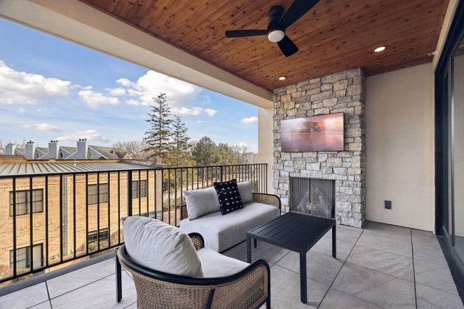 Gas fireplace and cedar ceiling are features of the covered balcony space | Image 17