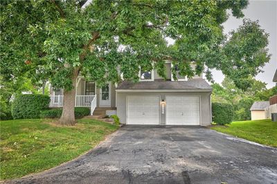 View of front of house with a porch and a front lawn | Image 1