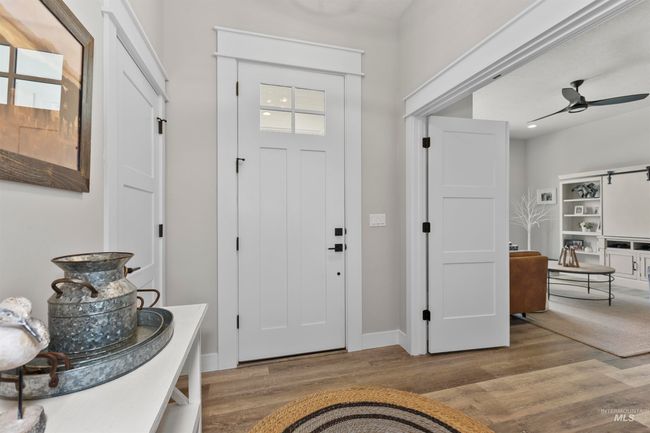Entryway with wood finished floors and a ceiling fan | Image 6