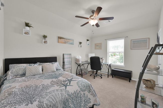 Bedroom 3 faces the side of the home, with views into the side yard. | Image 23