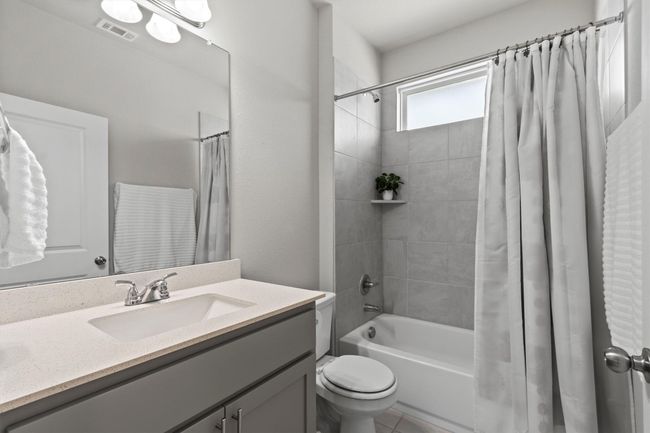 Full bathroom with vanity, shower / tub combo, and toilet | Image 12