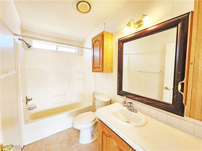 Full bath with toilet, shower / bath combination, and vanity | Image 18
