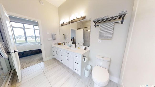 Full bath with double vanity, ensuite bathroom, tile patterned floors, and a shower with shower door | Image 20