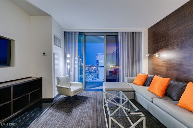 Living area with floor to ceiling windows and wood finished floors | Image 12