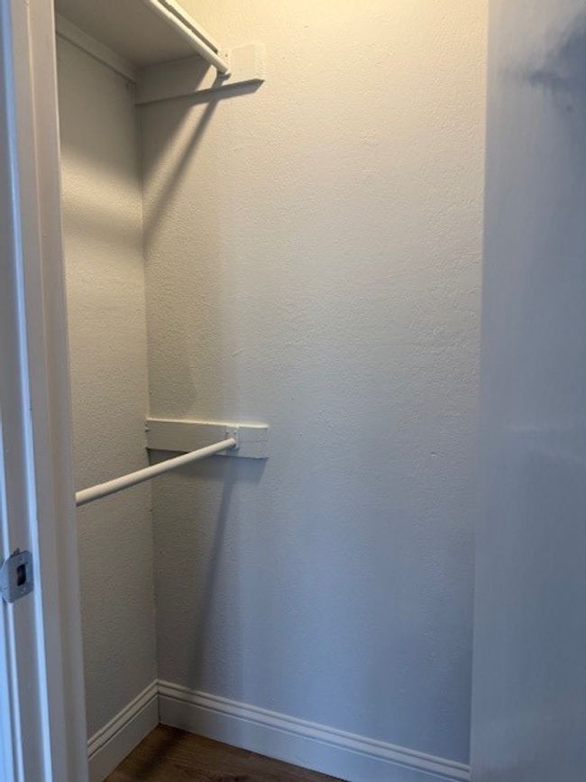 Walk in closet featuring dark wood finished floors | Image 8