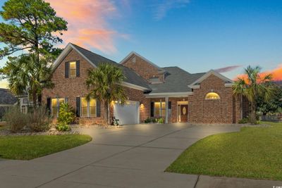 View of front of house with a garage and a yard | Image 1