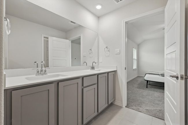 Ensuite bathroom with double vanity and tile patterned floors | Image 23