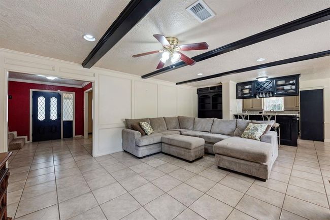 Living area opens directly to the kitchen and has built-in with glass doors to showcase your fine stemware. | Image 10