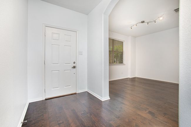 Foyer featuring baseboards and wood finished floors | Image 4