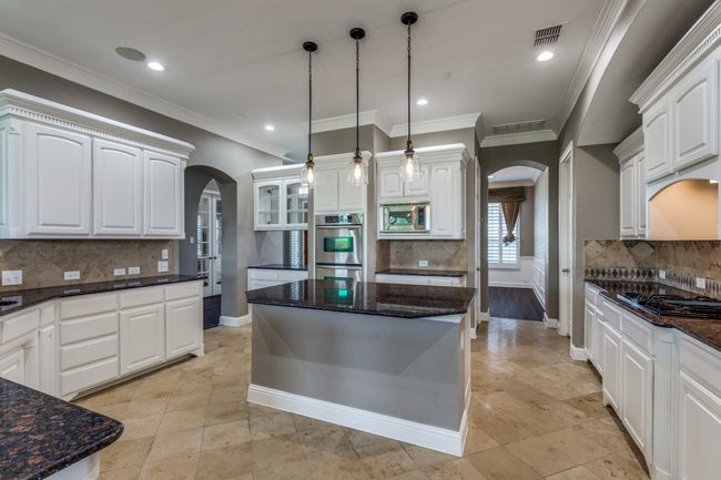 Kitchen featuring arched walkways, tasteful backsplash, appliances with stainless steel finishes, baseboards, and recessed lighting | Image 13