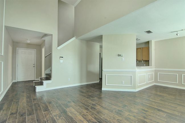 Empty room featuring dark hardwood / wood-style floors and rail lighting | Image 8