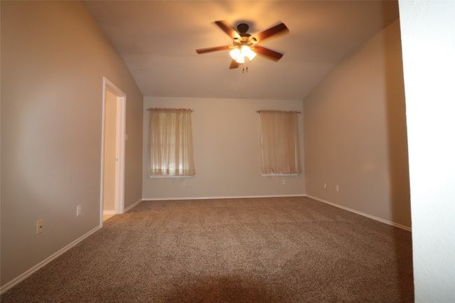 Unfurnished room featuring ceiling fan, carpet floors, and vaulted ceiling | Image 19
