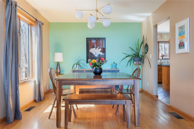 Dining space featuring visible vents, a chandelier, and light wood finished floors | Image 14