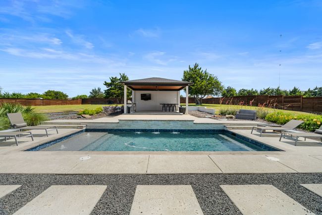 View of pool with a patio, a fenced backyard, and a gazebo | Image 36