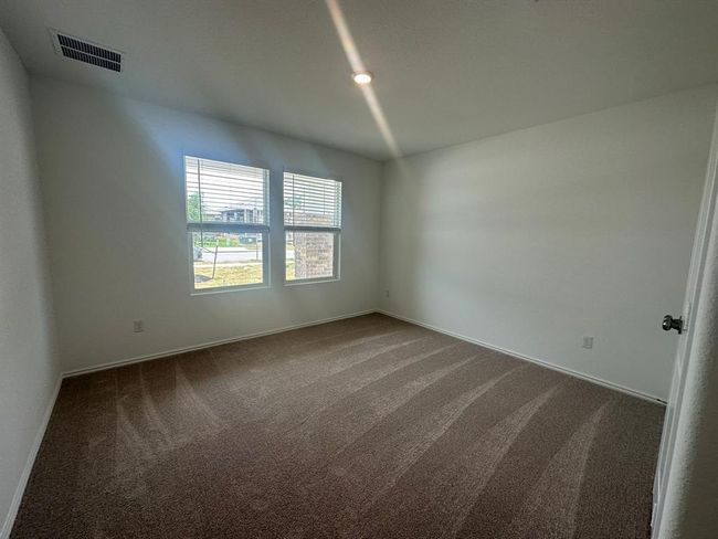 Spare room featuring dark carpet and baseboards | Image 8