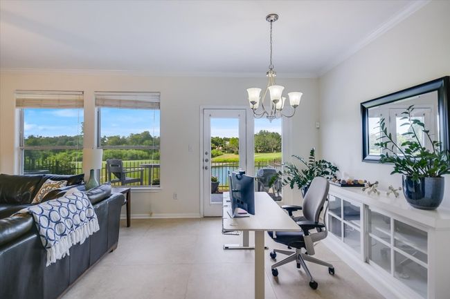 Office space with crown molding, plenty of natural light, a chandelier, and light tile patterned floors | Image 6