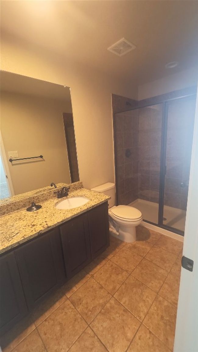 Bathroom featuring vanity, a stall shower, and tile patterned flooring | Image 14