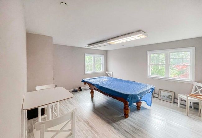 Playroom featuring baseboards, light wood-style floors, and pool table | Image 13