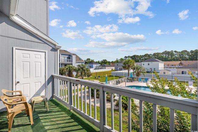 Balcony with a residential view and view of pool area | Image 19