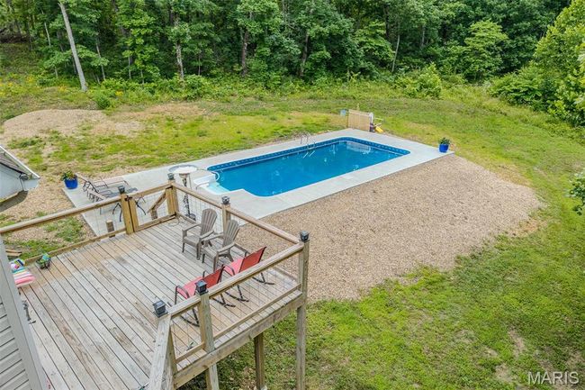 Outdoor pool with a deck and a patio | Image 71