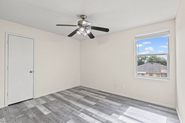Spare room with wood finished floors, a ceiling fan, and a textured ceiling | Image 18