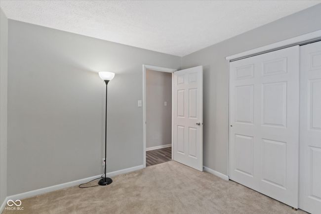 unfurnished bedroom featuring carpet floors and a closet | Image 9