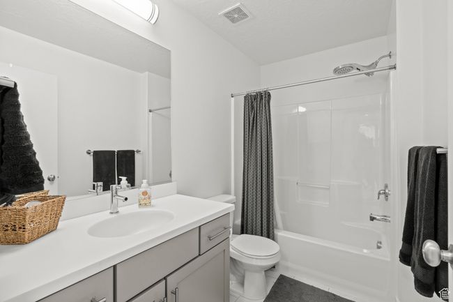Bathroom featuring vanity, shower / bath combo with shower curtain, and tile patterned flooring | Image 35