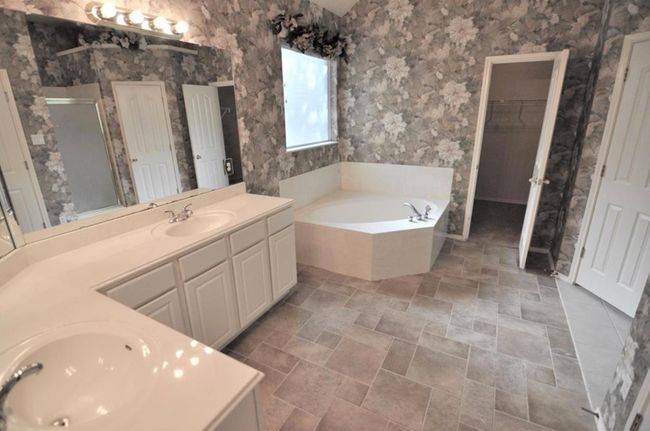 Large master bathroom with double vanity and huge walk-in closet | Image 5