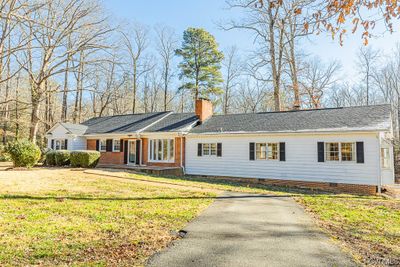 1970s addition to right side includes kitchen, dining area with stone fireplace, and guest room with 1 1/2 baths. | Image 2