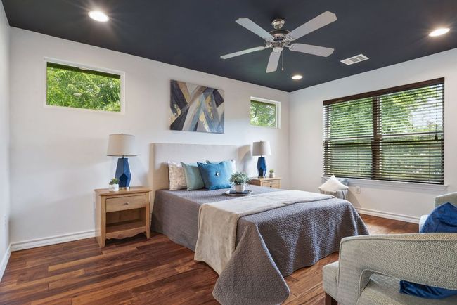 Bedroom with multiple windows, wood finished floors, baseboards, and recessed lighting | Image 22