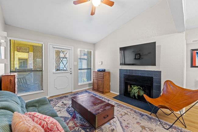 A cozy fireplace centers the living room. | Image 5
